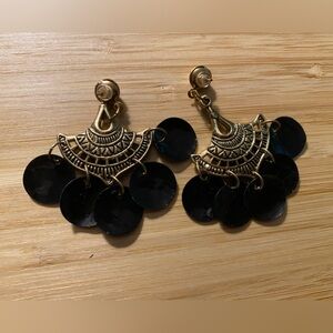 Black dangling earrings with gold tone design.  For pierced ears.